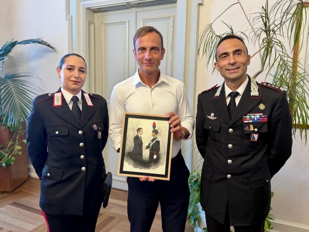 Massimiliano Fedriga con il colonnello Gianluca Migliozzi, in visita di commiato dal comando di Trieste dei Carabinieri. Insieme a loro Martina Di Gianvito, autrice del quadro donato al governatore